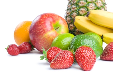 Fruits  Arrangement of various fresh ripe fruits  pineapple, bananas, orange,  apple, limes and strawberries closeup isolated on white background の写真素材