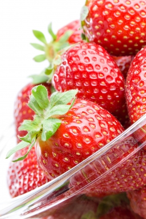 	Strawberries. Fresh ripe strawberries in a glass bowl close-up isolated on white background.の写真素材