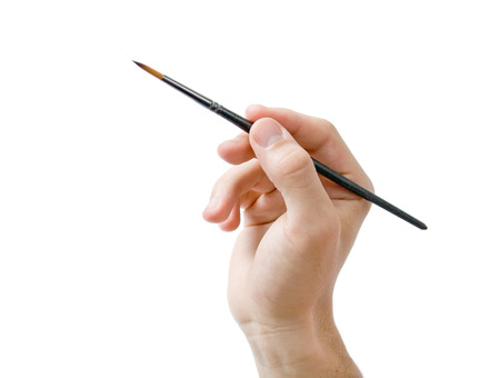 Male hand holding fine round  artists paint brush close-up isolated on white backgroundの写真素材