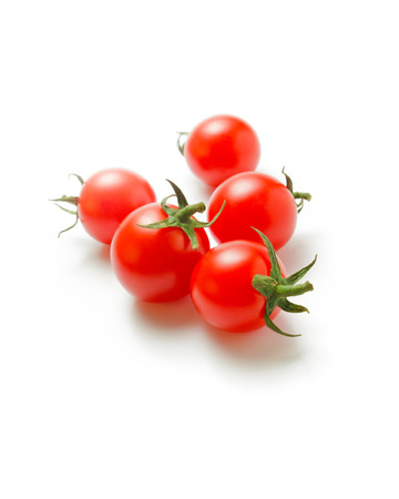 Cherry tomatoes. Fresh ripe cherry tomatoes scattered isolated on a white backgroundの写真素材