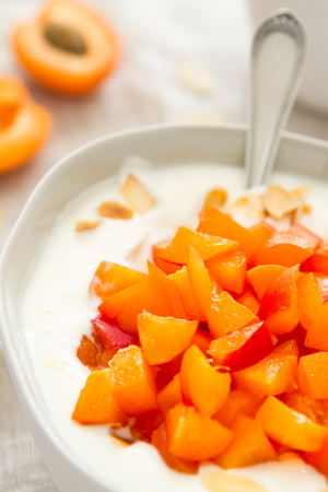 Yogurt with fresh apricots, close upの写真素材