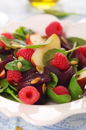 Fresh vegetarian salad with spinach, raspberries, beets and apples.の写真素材