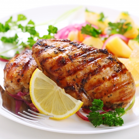 Grilled chicken breast on white plateの写真素材