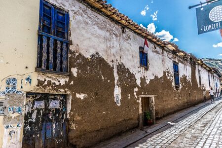 Bright blue door and wood carved balconies in elegant decay in Cusco, Peru.の写真素材