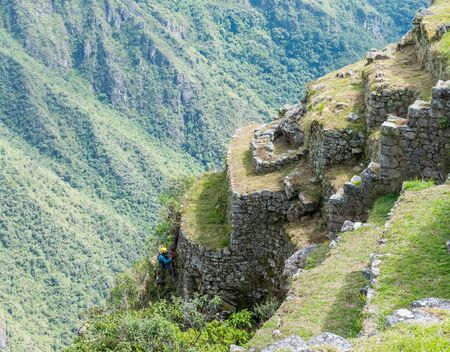 The workers at the Inca site of Machu Picchu in Peru trying to prevent erosion.の写真素材