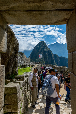 Entering through the doorway at Inca site of Machu Picchu in Peru.のeditorial素材