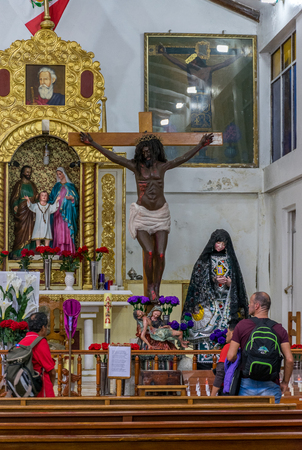 Black Jesus in the Virgin Del Carmen Spanish church in Aguas Calientes town square in Peru.のeditorial素材