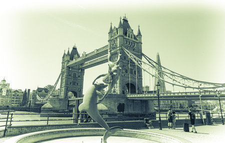 Girl With a Dolphin By the Tower Bridge Across the Thames In City of Londonの写真素材