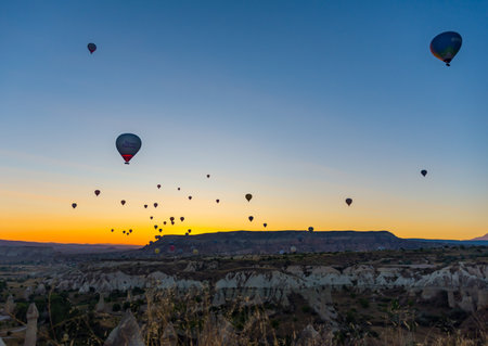 Hot Air Balloons Over Love Valley in Cappadocia, Turkey at Dawn.の写真素材