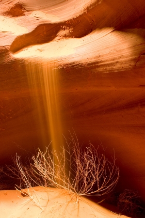 Sand cascading off the red rocks in Antelope Canyon, near Page Arizonaの写真素材