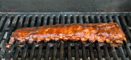 Barbecue Baby Back Ribs cooking on a BBQ Grillの写真素材