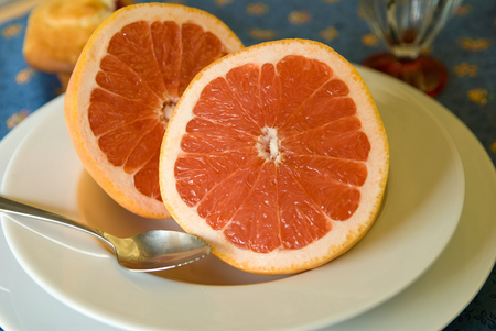 Breakfast of two halves of pink grapefruit.Shallow depth of fieldの写真素材