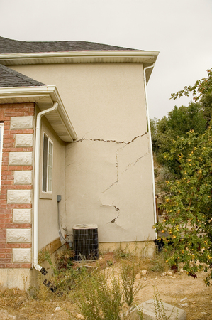 Shifting earth under the foundation of this new home caused major structural damage to the walls, floors, and windows of this beautiful home.の写真素材