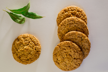 Top view of several oatmeal cookies with bay leafの写真素材