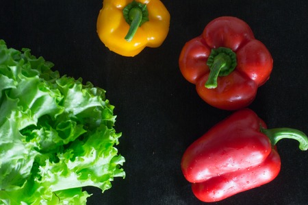 Freshly washed fresh vegetables over black background.の写真素材