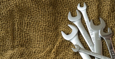 Set of wrenches tools on dark brown wool flat layの写真素材