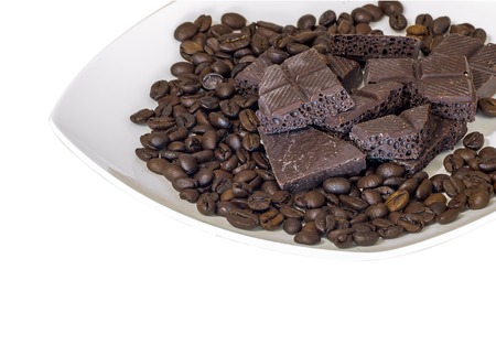 Chocolate and coffee beans on a white plate isolated backgroundの写真素材