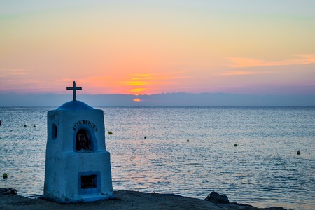 Agia marina monument drowned by the sea at sunset. Greece.の写真素材