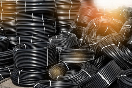 Coiled plastic pipes stored outdoors