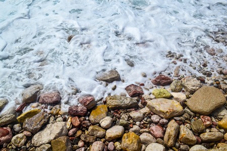 Sea waves, sea foam, break up on the coastal stones.の写真素材