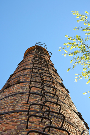 High industrial chimney view from below. Against the background of the skyの写真素材