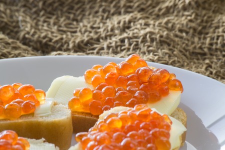 Red caviar with butter and baked bread. Close-up. Side viewの写真素材