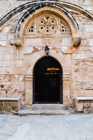 Arched entrance to the old church. Inside lit candles and lampsの写真素材