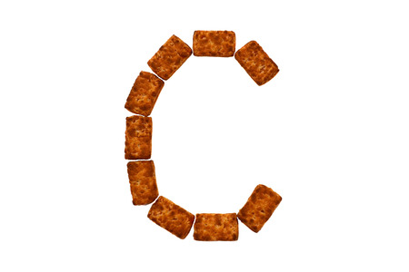 Alphabet made up of cookies on a white isolated background. letter Cの写真素材