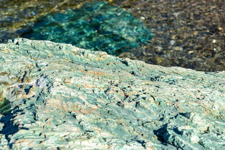 Underwater sea stones, surface with ripples and waves, beautiful pattern transparent clear waterの写真素材