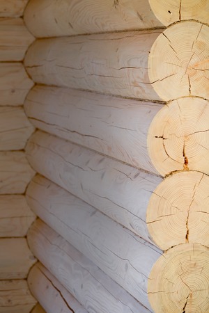 Round logs in the wall of a wooden house stacked on top of each other. Ecological house. Buildingの写真素材