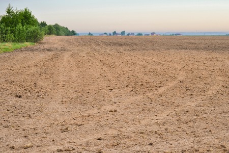 Freshly Plowed Field In Spring Ready For Cultivation. Spring landscape in the countryside with fields against the sky. Agriculture and farmingの写真素材