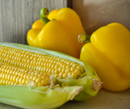 Fresh corn on the cob and sweet yellow pepperの写真素材