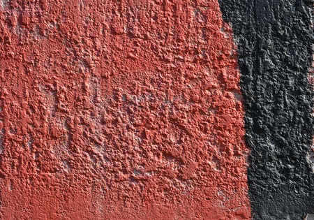 Red and black paint on the wall. Part of the graffiti. Grunge. Texture backgroundの写真素材