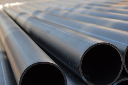Plastic pipes in stock of finished products stacked in packs