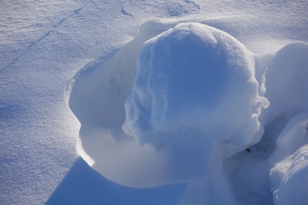 Winter background. Abstract. Snow drifts. Smooth transitions of lines of light and shadow. Snow on a sunny day.の写真素材
