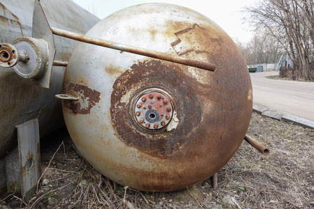 Close up background of rusty metal tank with rusty circular hole.の写真素材