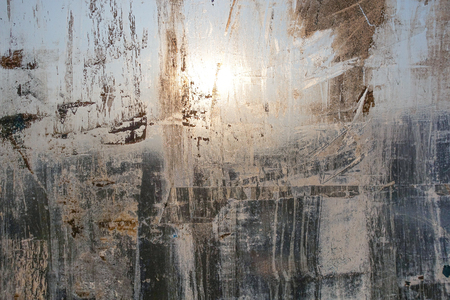 Abstract background. Window chaotically smeared with paint, illuminated by the sun.の写真素材