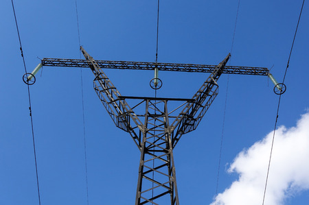 High-voltage tower on a background of blue sky