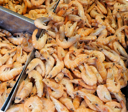 Frozen unpeeled prawns in the store. Frozen food salesの写真素材