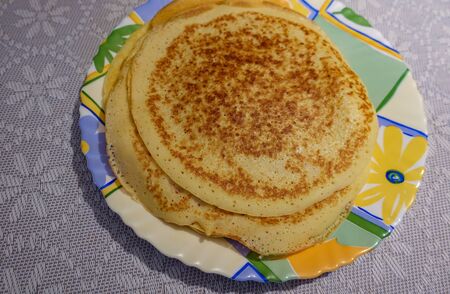 A stack of pancakes cooked at home. On the plate. Top view