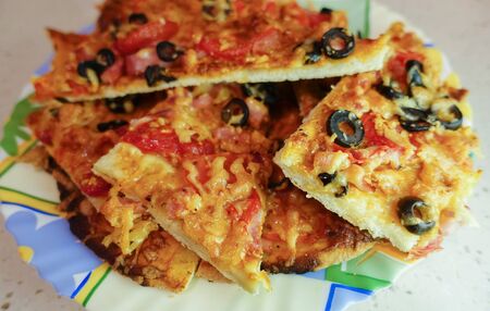 Delicious homemade homemade pizza. Sliced on a plate