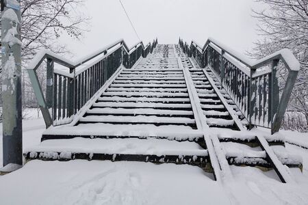 Old overpass over a railway line covered in snow. Russia.の写真素材