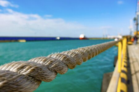 Handrail made of nautical rope at seaの写真素材
