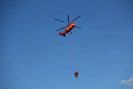 2021 June 4 Moscow region Podolsk - Helicopter refill bucket in lake for fire fighterのeditorial素材