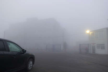Thick fog in the city. Russia early foggy morning.