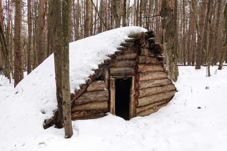wooden hut in the forest. Abandoned building made of logs in the snow. Russiaの写真素材