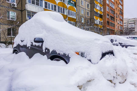 The car is covered in snow. Winter in Russiaの写真素材