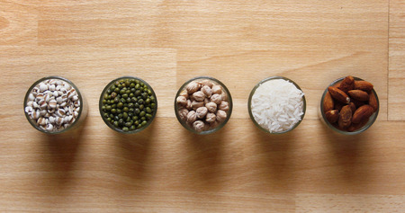 Different kinds of Grains, lentil, peas in dish on wooden table