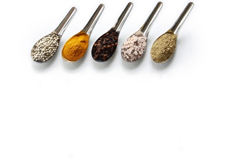Spices. Spice and herbs in steel spoon isolated on white background.の写真素材