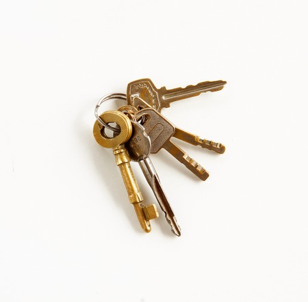 vintage golden keys are on white background.の写真素材
